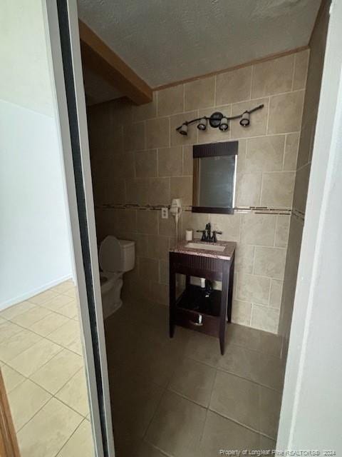 bathroom with tile patterned floors, toilet, and sink