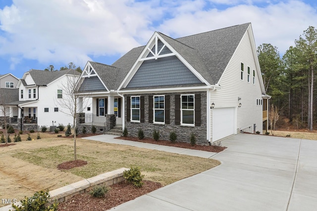 craftsman inspired home with a garage and a front yard