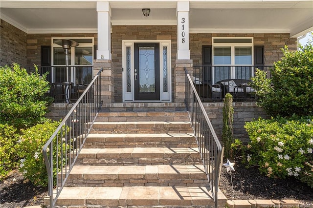 view of exterior entry with a porch