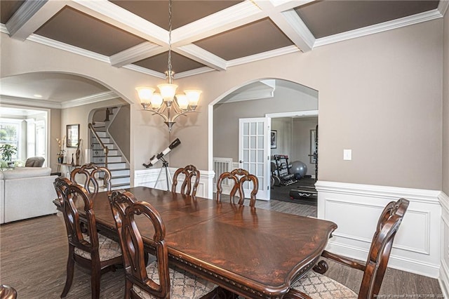 dining room featuring dark hardwood / wood-style flooring, beamed ceiling, an inviting chandelier, crown molding, and coffered ceiling