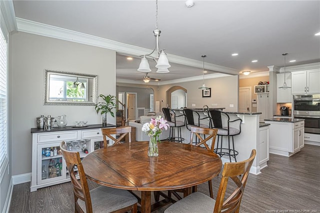 dining area featuring crown molding and dark hardwood / wood-style floors