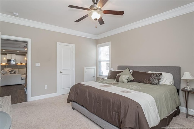 carpeted bedroom featuring ceiling fan and crown molding