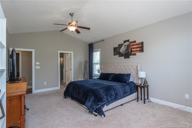 carpeted bedroom with ceiling fan, ensuite bathroom, and lofted ceiling