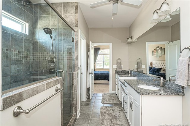 bathroom featuring ceiling fan, vanity, an enclosed shower, and a wealth of natural light