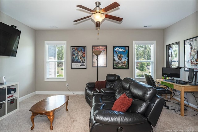 living room with ceiling fan, light colored carpet, and a wealth of natural light