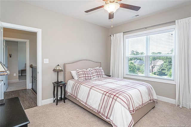 bedroom featuring ceiling fan and light colored carpet