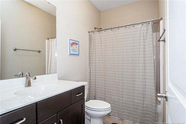 bathroom featuring toilet, tile patterned flooring, and vanity