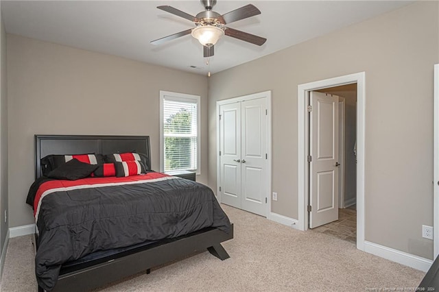 carpeted bedroom featuring ceiling fan and a closet