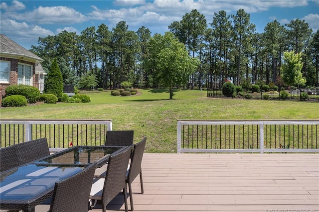 wooden terrace featuring a lawn