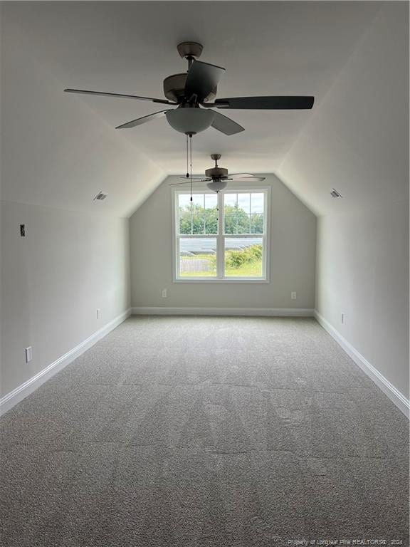 additional living space featuring lofted ceiling, ceiling fan, and carpet