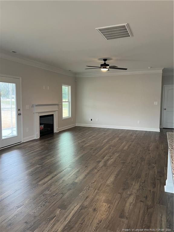 unfurnished living room with crown molding, ceiling fan, and dark hardwood / wood-style flooring