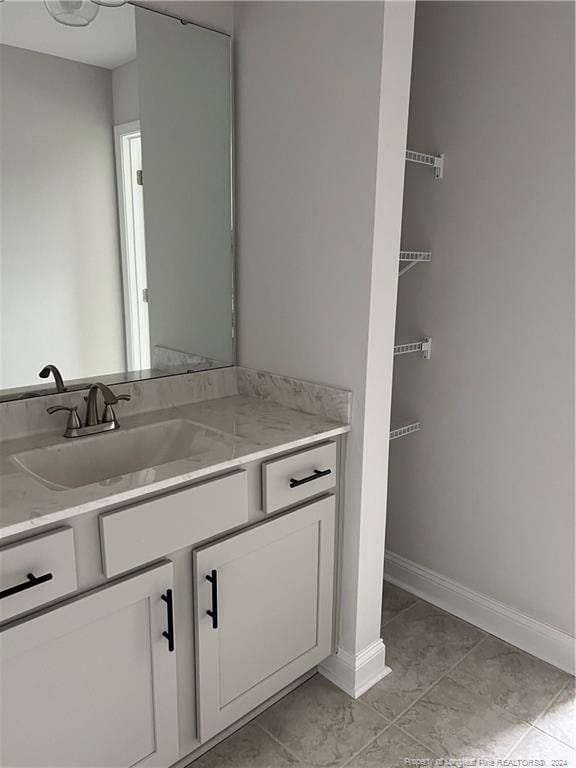 bathroom with vanity and tile patterned flooring