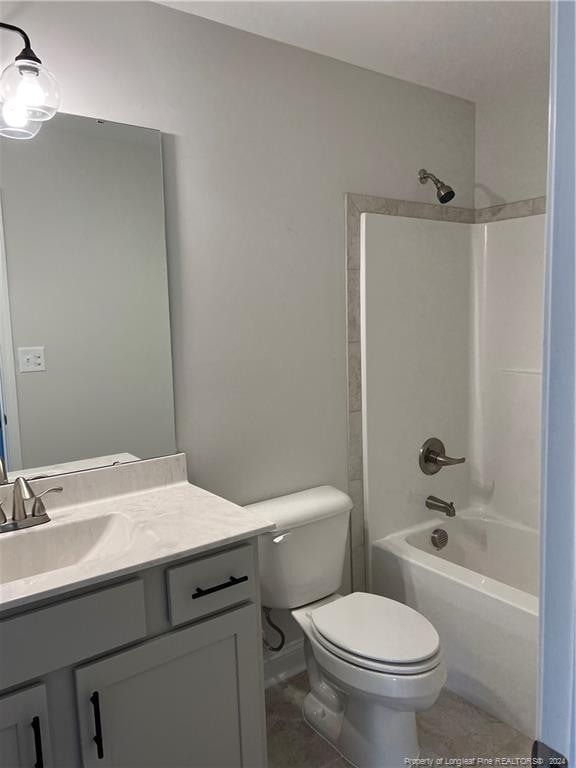 full bathroom with shower / bathing tub combination, vanity, tile patterned flooring, and toilet