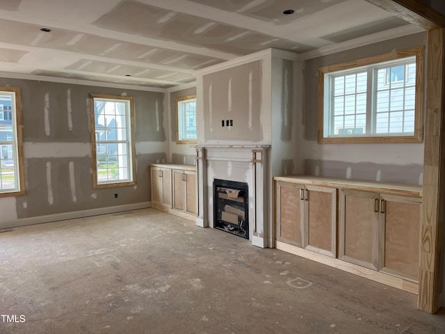 unfurnished living room with ornamental molding