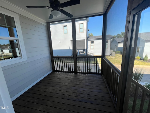 unfurnished sunroom featuring plenty of natural light and ceiling fan