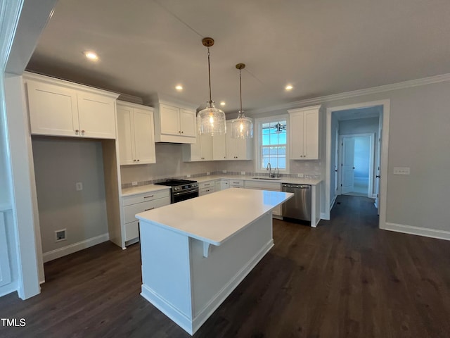 kitchen with white cabinetry, sink, a kitchen island, and stainless steel appliances