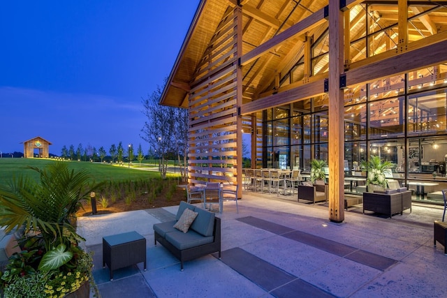 patio terrace at dusk featuring a gazebo and an outdoor living space