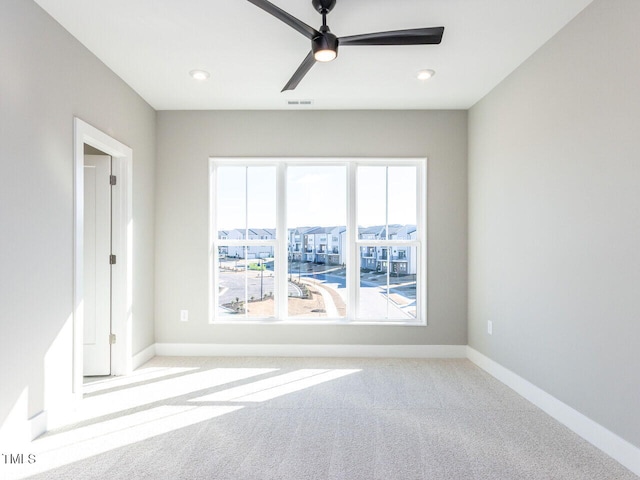 empty room featuring light carpet and ceiling fan