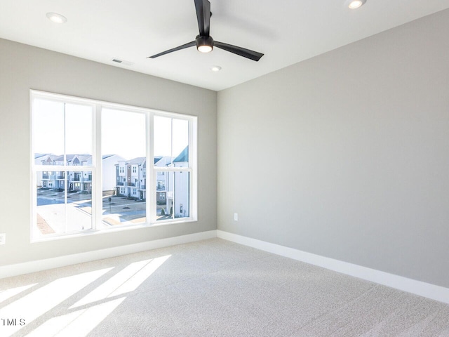 spare room with ceiling fan and carpet flooring