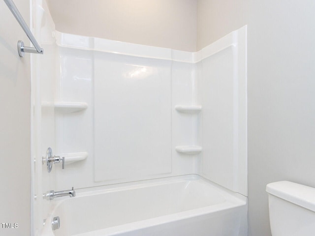 bathroom featuring bathing tub / shower combination and toilet