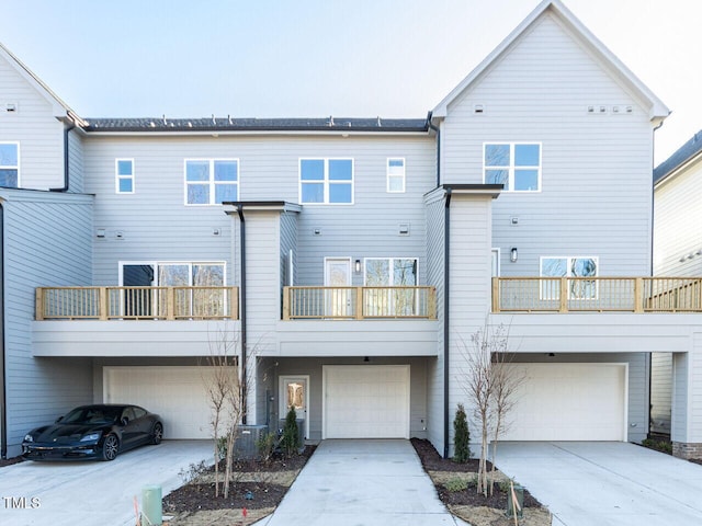 rear view of property featuring a garage and a balcony