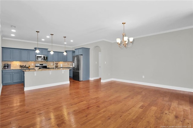 kitchen featuring crown molding, light wood-type flooring, decorative light fixtures, and appliances with stainless steel finishes