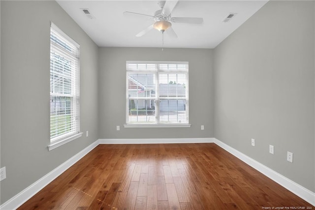 spare room with hardwood / wood-style flooring and ceiling fan