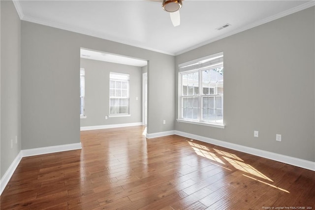 spare room featuring ceiling fan, wood-type flooring, and ornamental molding