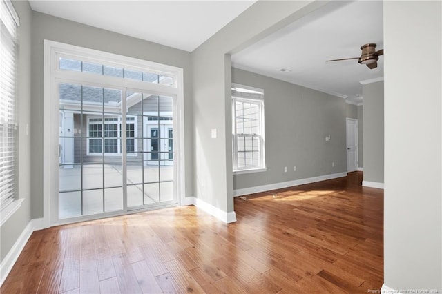 unfurnished room with hardwood / wood-style flooring, ceiling fan, and crown molding