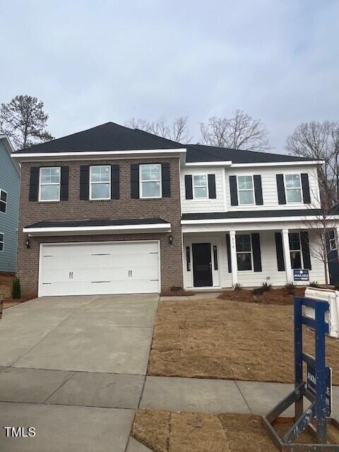 view of front of home with covered porch and a garage