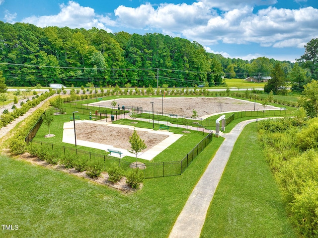 view of community with a lawn and volleyball court