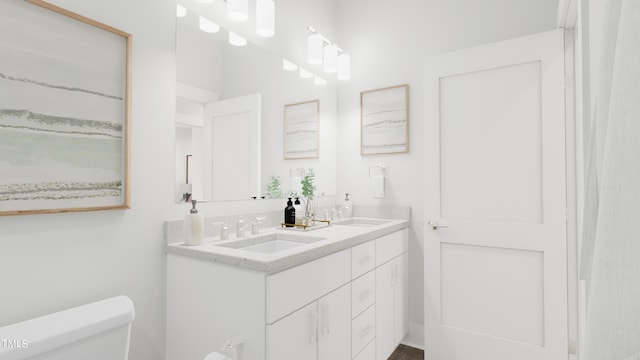 bathroom featuring vanity and toilet