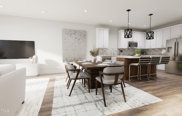 dining space with light hardwood / wood-style floors