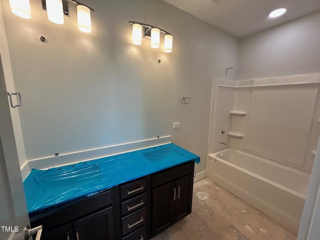 bathroom featuring vanity and  shower combination