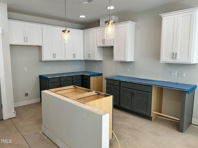 kitchen with white cabinets, a kitchen island, hanging light fixtures, and gray cabinetry