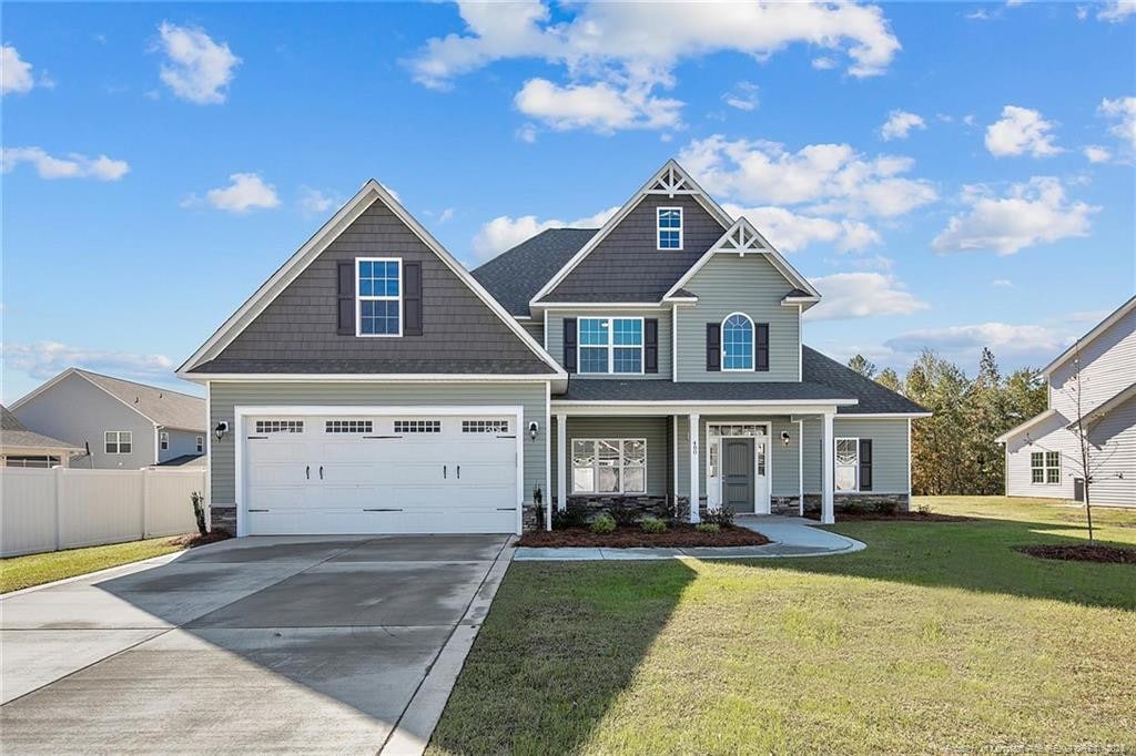 craftsman-style house with a front yard and a garage