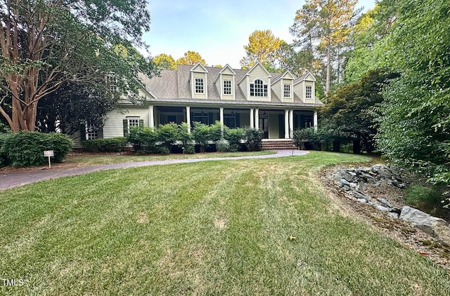 cape cod-style house with a front yard