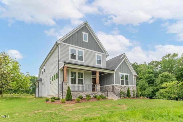 craftsman-style house featuring a porch and a front yard