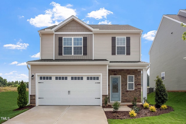 view of front of home with central AC unit, a garage, and a front lawn