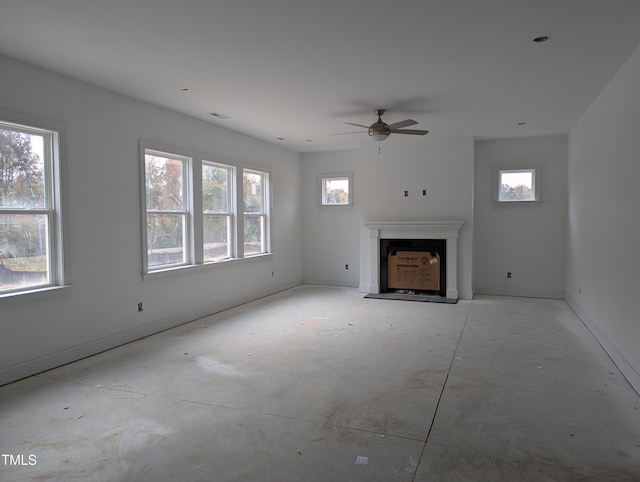 unfurnished living room with ceiling fan