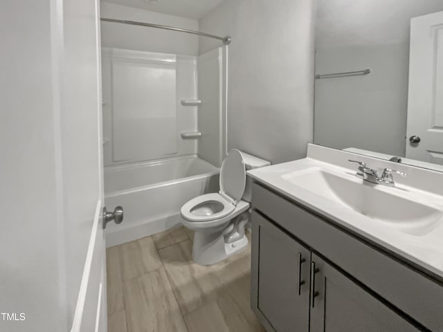 full bathroom with toilet, vanity, and washtub / shower combination