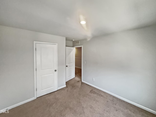 empty room featuring light colored carpet