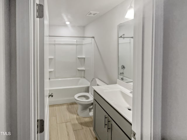 full bathroom featuring toilet, vanity,  shower combination, and hardwood / wood-style flooring