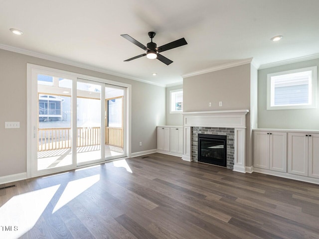 1713 Grassy Falls Ln, Wendell, NC 27591 - unfurnished living room with crown molding, ceiling fan, dark wood-style flooring, recessed lighting, and a brick fireplace