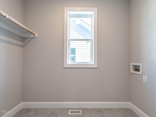 laundry area featuring washer hookup and light tile patterned floors