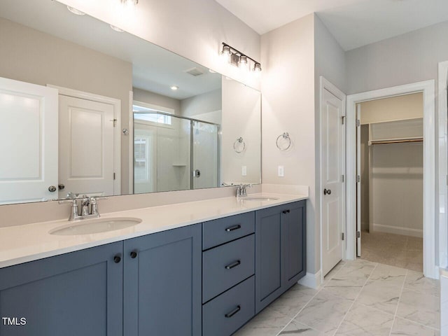 1713 Grassy Falls Ln, Wendell, NC 27591 - full bath featuring a stall shower, double vanity, a spacious closet, and marble look tile flooring