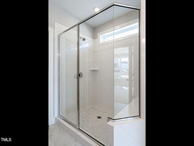 bathroom featuring a shower with shower door