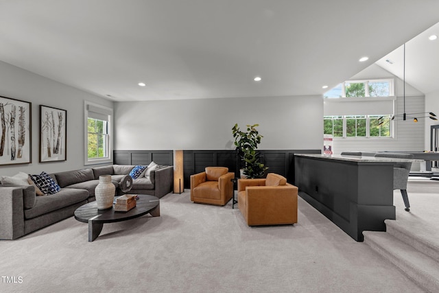 living room featuring light colored carpet and lofted ceiling