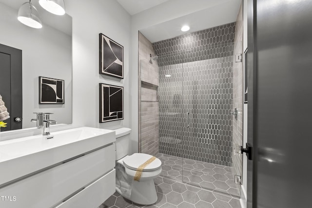 bathroom featuring walk in shower, tile patterned flooring, vanity, and toilet