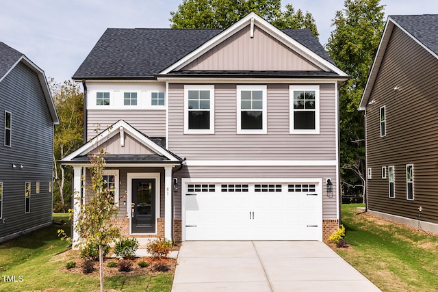 craftsman inspired home with a garage and a front yard